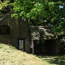 Stile, lychgate and former mortuary adjoining lychgate at south about 20m south-east of the Church of St Morwenna