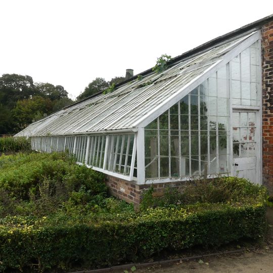 Stone wall and hothouses in Western Kitchen Garden