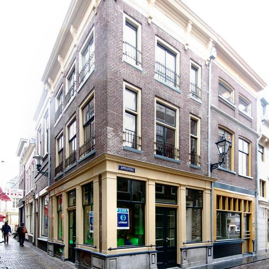 Pand met gepleisterde lijstgevel, de lijst voorzien van consoles