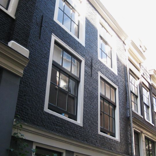 Huisje onder dwars dak met zeer oude vensterkozijnen waarin latere goede roedenverdelin