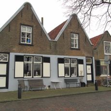 Gabled building under roll cover