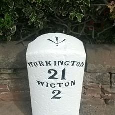 Milestone, N side of village, by a farm house