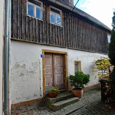 Ländliches Wohnhaus (Obergeschoss Fachwerk, verbrettert) Am Schloßberg 7