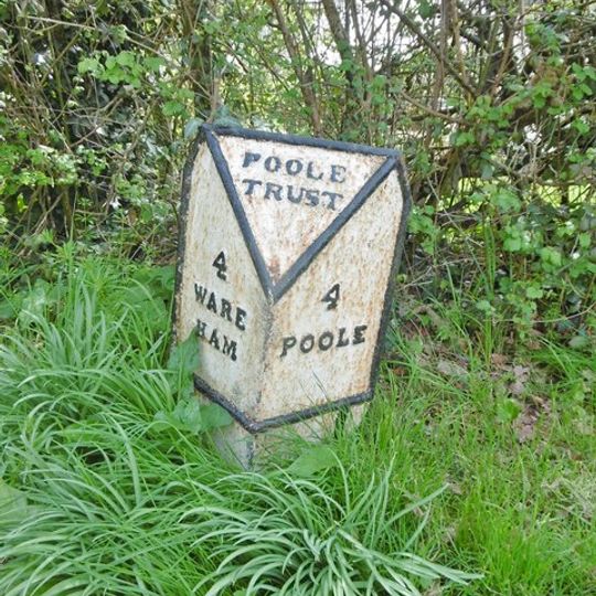 Milepost, Lytchett Minster,  opposite Church and School