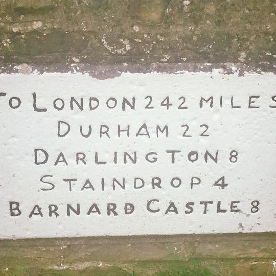 Milestone, village Main Road