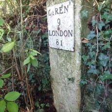 Milestone, E of entrance to football ground.