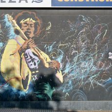 Mural representando al guitarrista Jimi Hendrix tocando la guitarra.