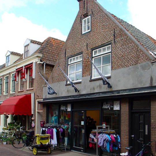 Huis met puntgevel met toppilaster en jonger benedendeel