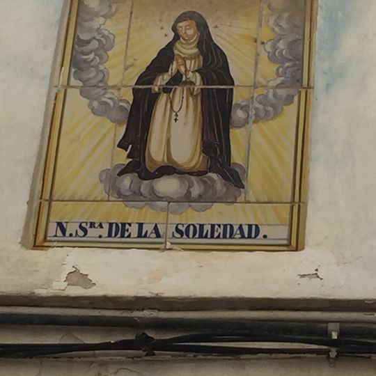 Ceramic panel of Our Lady of Solitude at 66 Benacacira street