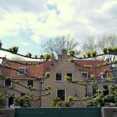 Huis met lage gevel met rechte kroonlijst met opkamer